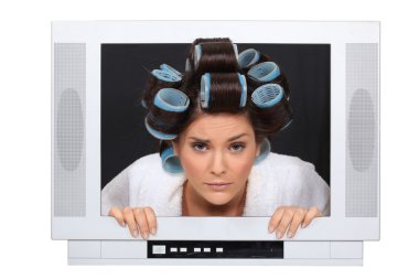 Woman in hair rollers trapped in television clipart