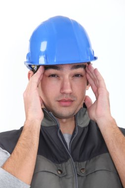 Workman having migraine clipart