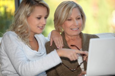 Mother and daughter on the computer clipart