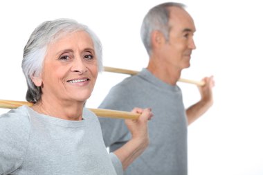 Portrait of an old couple doing exercise clipart