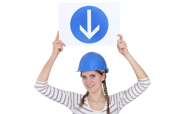 Woman holding directional road sign — Stock Photo, Image