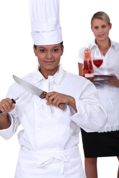 Chef-kok en serveerster samen poseren — Stockfoto