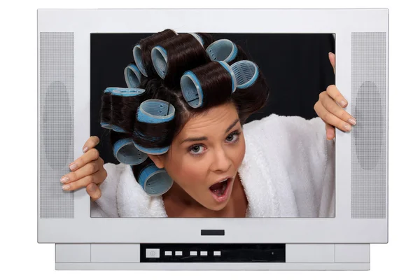 Girl in TV screen with hair curlers — Stock Photo, Image