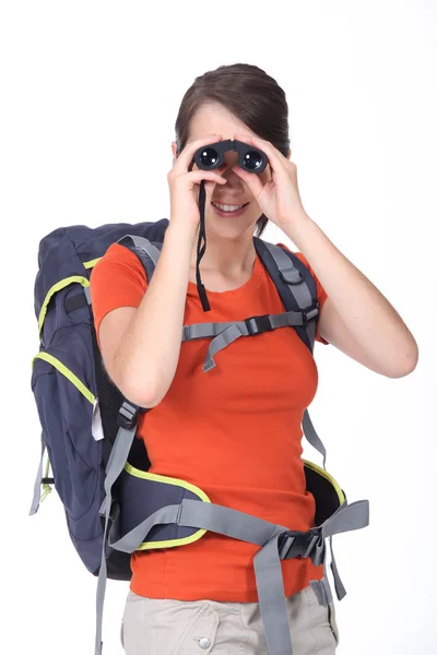 Woman looking through binoculars — Stock Photo, Image