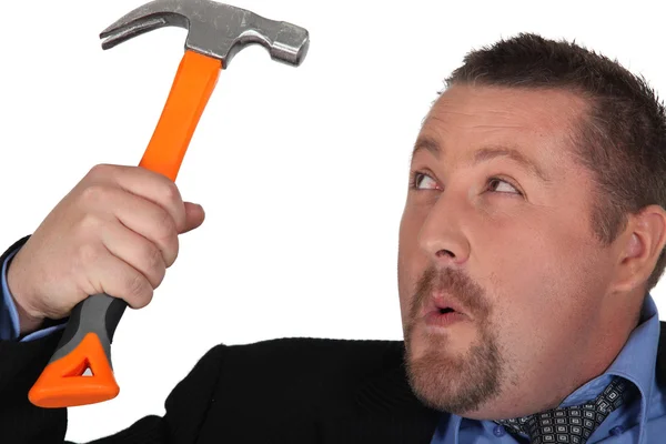 Empresário segurando um martelo — Fotografia de Stock