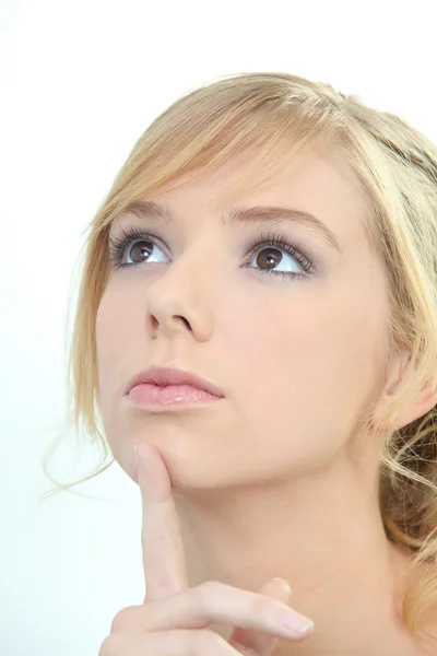 Young woman thinking with her finger to her chin — Stock Photo, Image