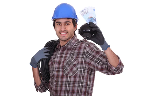 Worker with piggy bank and bills — Stock Photo, Image