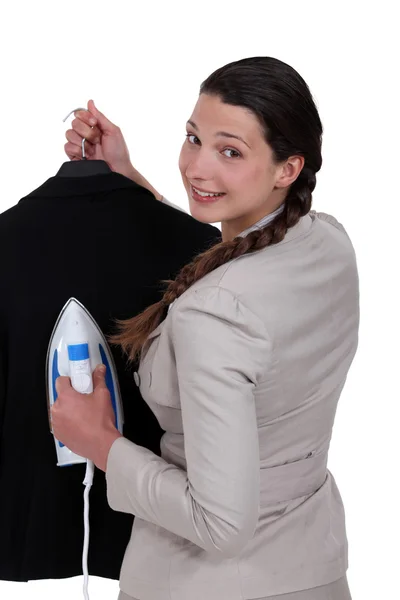 Woman ironing jacket — Stock Photo, Image