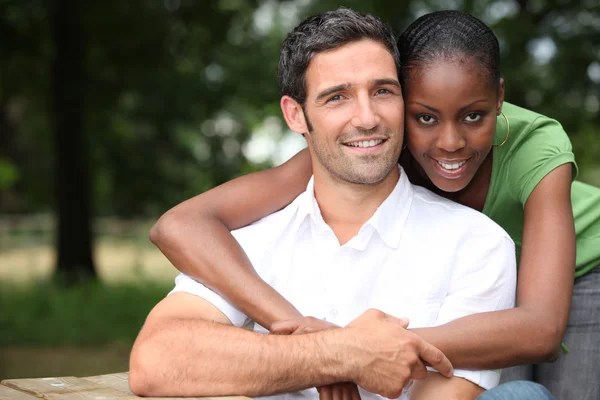 Mixed-race couple at the park — Stock Photo, Image