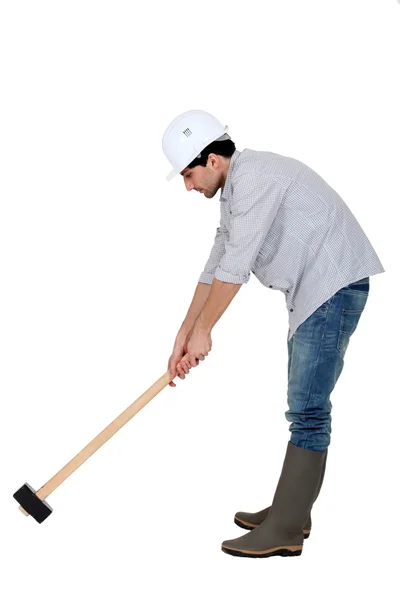 Craftsman holding an enormous hammer — Stock Photo, Image
