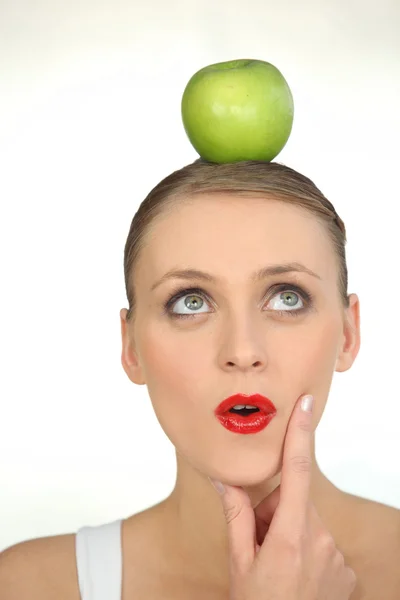 Woman with an apple on her head — Stock Photo, Image