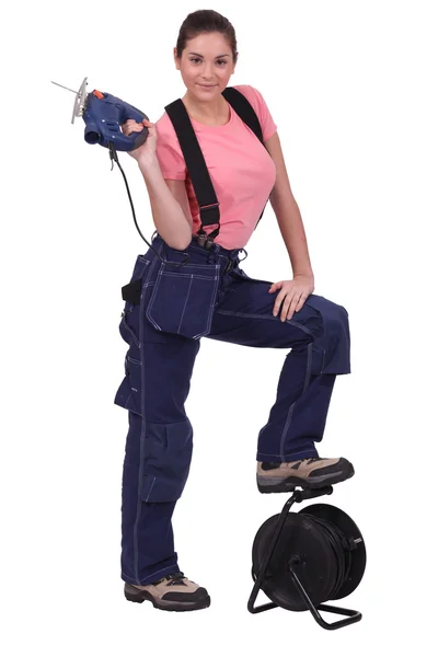Tradeswoman holding up a jigsaw Stock Picture