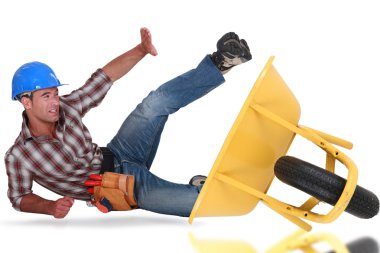 Laborer tumbling down from a barrow clipart