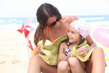 Mother and daughter on beach clipart