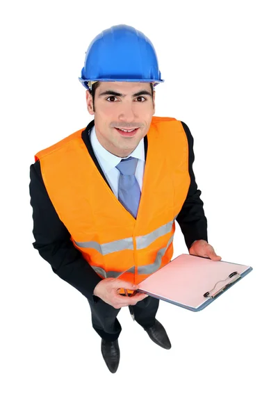 Affärsman som tar anteckningar på en byggarbetsplats — Stockfoto