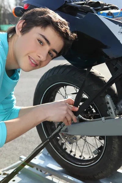 stock image Teenage boy repairing motorcycle