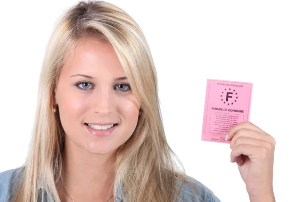 Young woman holding up a French driving licence — Stock Fotó