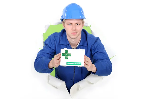 Workman showing first aid kit — Stock Photo, Image