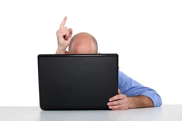 Man with laptop pointing Royalty Free Stock Images