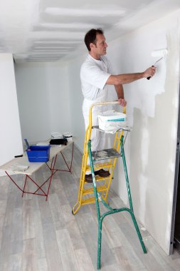 Man painting a wall clipart