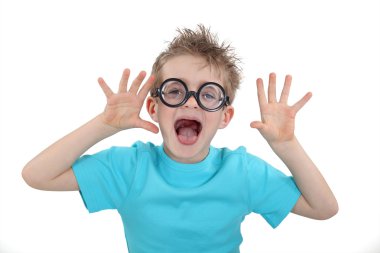Child wearing wacky glasses and making a silly face clipart