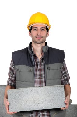 Young mason carrying a cinderblock clipart