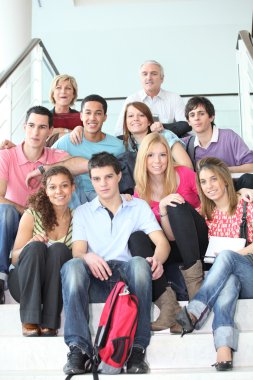 Students sat on school steps clipart