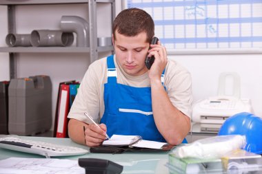 Man checking stock and ordering new parts clipart