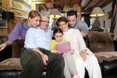 Family gathering at home with laptop clipart