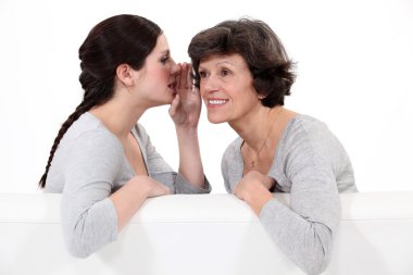Woman telling her mother a secret clipart