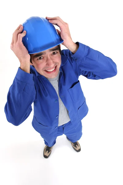 Craftsman in panic holding his helmet — Stock Photo, Image