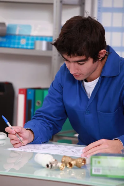 Young man in workshop — Stock Photo, Image