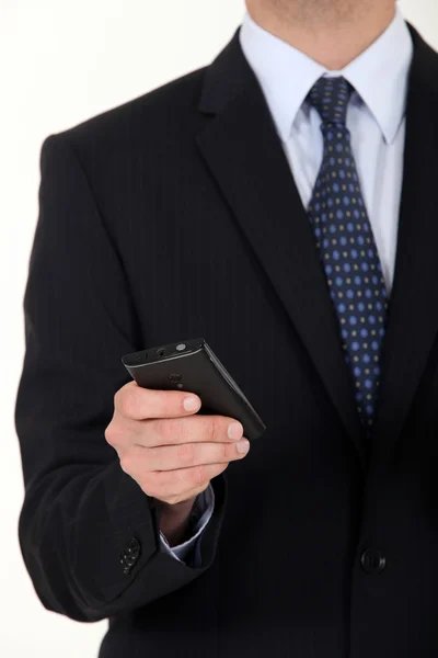 Close-up of businessman sending text message from mobile — Stock Photo, Image