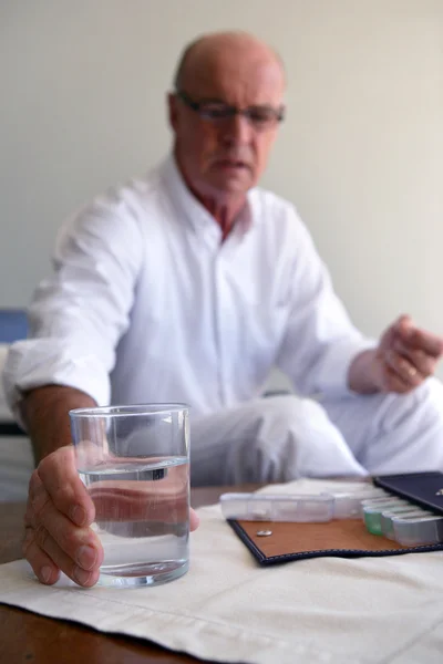 Hombre mayor tomando su medicina — Foto de Stock