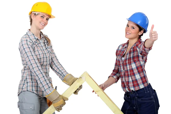 Two women with wooden truss — Stock Photo, Image