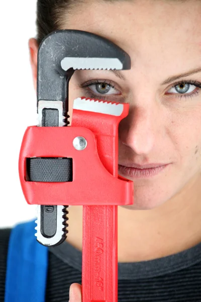 Craftswoman holding a spanner — Stock Photo, Image