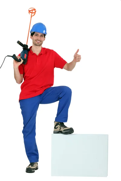 Man holding paint mixer — Stock Photo, Image