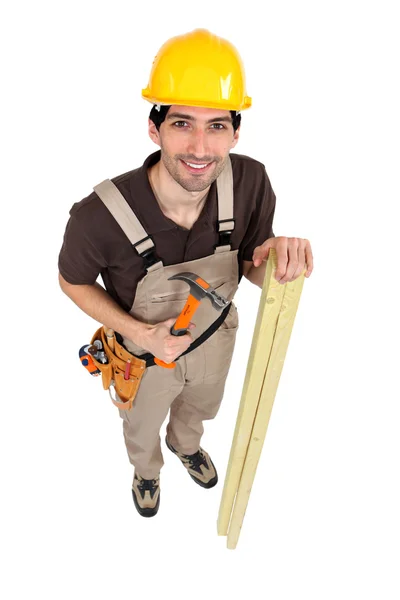 Carpenter with hammer and plank — Stock Photo, Image