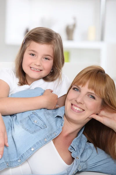 Young mother and daughter at home — Stock Photo, Image