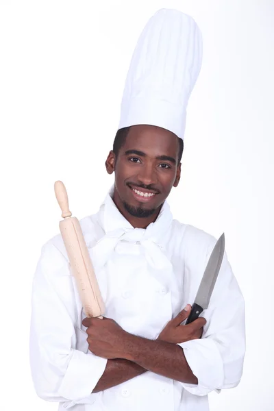 Chef holding knife and rolling pin — Stock Photo, Image