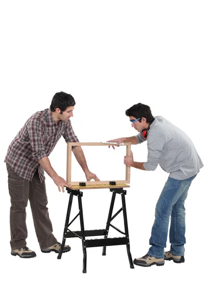 Carpenter and teenage helper — Stock Photo, Image