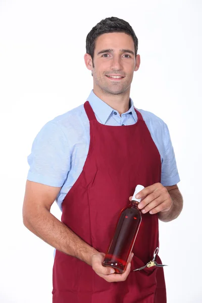 Waiter holding bottle of wine — Stock Photo, Image