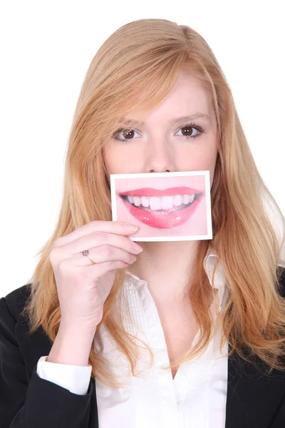 Woman holding photo of mouth — Zdjęcie stockowe