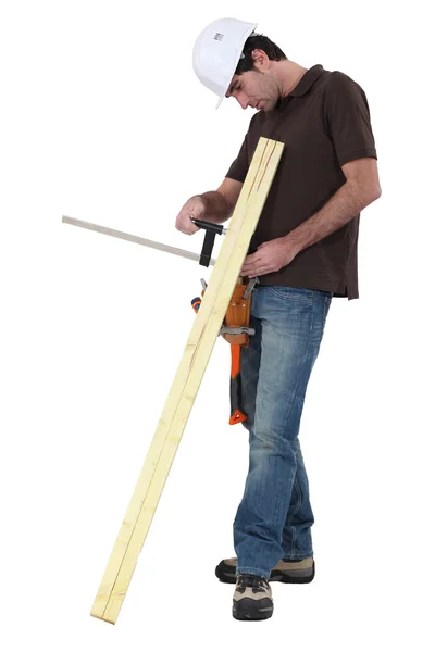 Tradesman gluing two wooden planks together — Stock Photo, Image