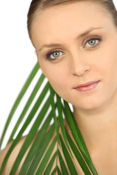 Blond woman posing with leaf — Stock Photo, Image