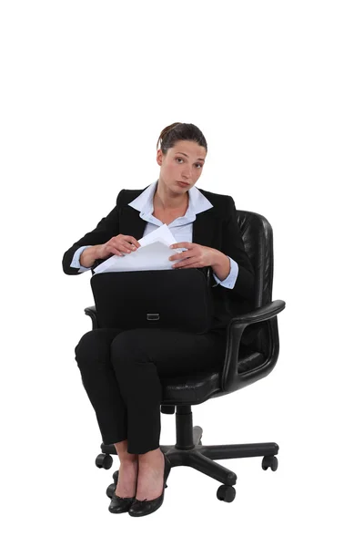 Businesswoman pulling a document out of her briefcase — Stock Photo, Image