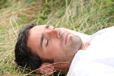 Man sleeping on the grass clipart