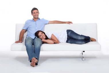 Couple on white sofa clipart