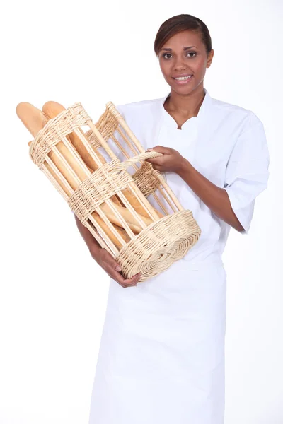 Brunette woman with a basket of bread — Stock Photo, Image