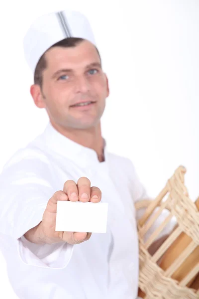 Baker with breadbasket and business card — Stock Photo, Image